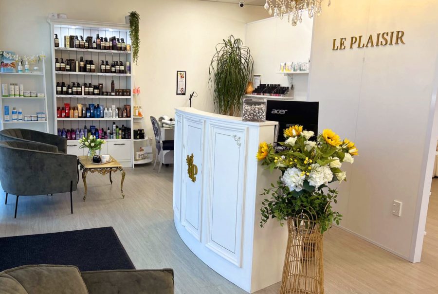 Le Plaisir beauty salon reception area showing body treatments and hair styling products